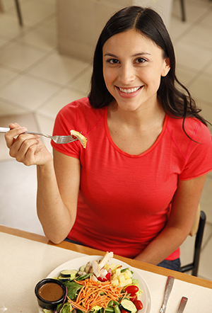 Woman eating salad.